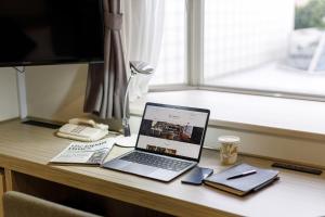 a laptop computer sitting on top of a desk at Shinagawa Prince Hotel N Tower in Tokyo