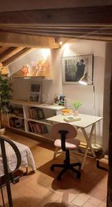 a room with a desk and a table and a chair at La Casa del Gallo in Radicondoli
