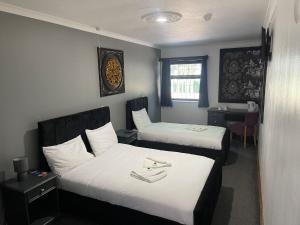a hotel room with two beds and a desk at Stay Inn Express, Cambridge in Cambridge +49 photos
