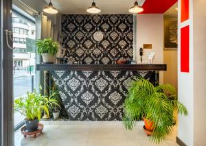 a room with potted plants on a wall at Hotel la Perle Montparnasse in Paris