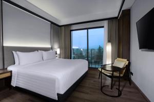 Postel nebo postele na pokoji v ubytování Grand Aston Puncak Hotel & Resort