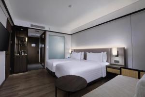 Postel nebo postele na pokoji v ubytování Grand Aston Puncak Hotel & Resort