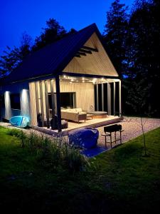a pavilion with a couch and a table in a yard at Lavender Resort in Molėtai