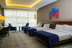 a hotel room with two beds and a table at Gold Majesty Hotel in Bursa
