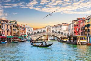a gondola in a canal in front of a bridge at Venice Nora's House in Mestre
