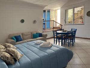 a living room with a blue couch and a table at Casa Rosetta in Anacapri