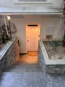 a front door of a house with a white door at City Garden Studio Apartment in Belgrade in Belgrade