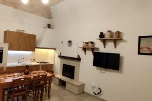 a kitchen and dining room with a table and a fireplace at A casa di Gino in Molfetta