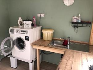 a kitchen with a washing machine and a sink at Ferienhaus Klaus in Kirchenlamitz