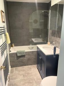a bathroom with a tub and a sink and a shower at Central Georgian Garden Flat with Free Parking in Bath +37 photos