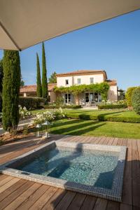 a swimming pool in front of a house at Coquillade Provence - Relais & Châteaux in Gargas