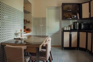 a kitchen with a table and chairs in a room at Guest House Melissa in Duisi