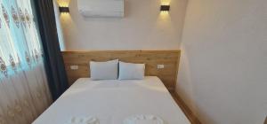 Postel nebo postele na pokoji v ubytování Dila Apart Hotel