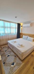 Postel nebo postele na pokoji v ubytování Dila Apart Hotel