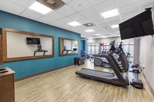 a fitness room with a treadmill and a flat screen tv at Hampton Inn - Atmore in Atmore