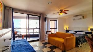 a bedroom with a couch and a bed and a balcony at Flat no Iate Plaza Hotel in Fortaleza +10 photos