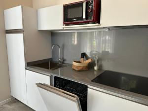 a kitchen with a sink and a microwave at Palazzo del Vescovo in Gozzano +22 photos