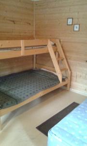 Zimmer mit 2 Etagenbetten in einer Hütte in der Unterkunft Pihlajamäen Lomamökit in Vanhakylä