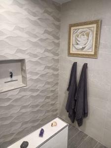 a bathroom with a sink and a painting on the wall at La Catumbela in Tuineje +24 photos