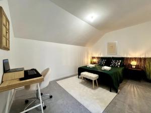 a room with a bed and a desk and a table at Family house - Exterieur 4 pers - 3 beds in Fontainebleau