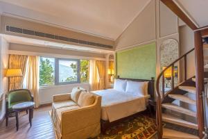 a hotel room with a bed and a staircase at Namah Nainital, a member of Radisson Individuals Retreats in Nainital +37 photos