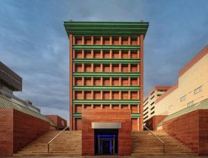 a tall red brick building with a green at Hotel Il Palazzo in Fukuoka