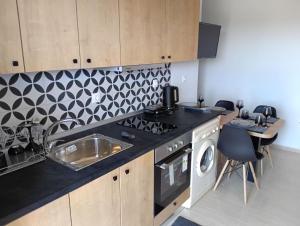a kitchen with a sink and a stove top oven at Helene Mirteni in Ialysos