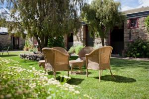 a group of chairs sitting in a yard at Olivers Central Otago in Clyde