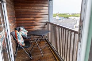 a small balcony with two chairs and a table at The View from BIDE in Thurso