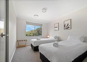 a bedroom with two beds and a window at Cusmano Retreat - contemporary rural homestay in Margaret River Town