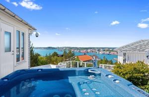 a hot tub on a balcony with a view of the water at Villa Freya with stunning sea view in Kristiansund