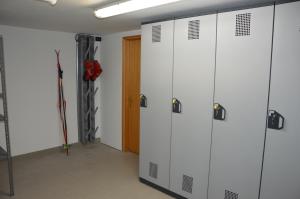 a row of lockers in a room with a door at Casa Olivati in Pellizzano