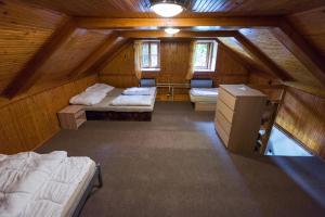 a attic room with two beds and a desk at Statek U Šťástků in Vodňany +38 photos