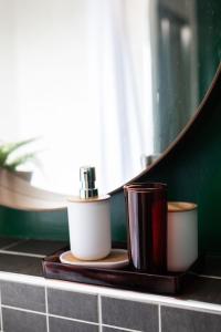 a bathroom counter with two cups and a mirror at City Hall Penthouse Duplex - Incredible Views & Sleeps 8 & Balcony & Very Modern and spacious in Belfast +79 photos