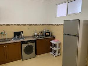 a kitchen with a refrigerator and a dishwasher at العقارية in Beni Enzar