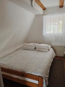 a bed with two pillows on it in a room at Vikendica Eden in Vlasic +13 photos