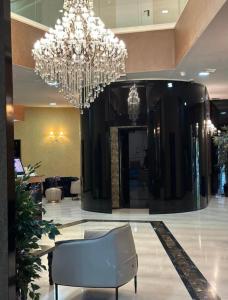 a large lobby with a chandelier and a chair at TC BiG APARTMENTS in Budva +20 photos