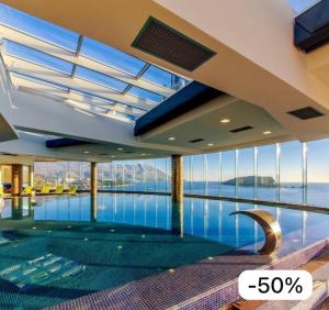 a swimming pool in a building with a view of the water at TC BiG APARTMENTS in Budva