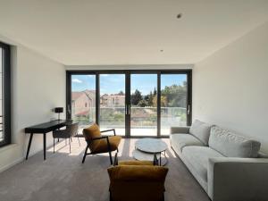 a living room with a couch and a table and a piano at Hotel Oscar in Kaštela