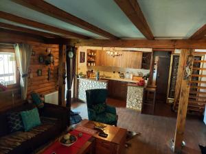 a living room with a couch and a kitchen at Planinska kuća HIL - Bjelašnica in Sarajevo
