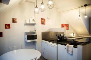 a kitchen with a table and a stove top oven at Smartappart Cherbourg (la rose des vents) in Cherbourg en Cotentin