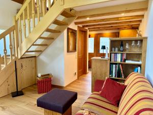 a living room with a couch and a staircase at Hollhouse - Bed & Breakfast in Hinterzarten +79 photos
