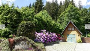 a house with a bunch of flowers in front of it at Hollhouse - Bed & Breakfast in Hinterzarten