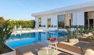 a villa with a swimming pool and a house at Villa Gaia Green-Adults only in Kolimbia +24 photos