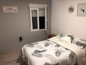 a bedroom with a bed and a window at Vila Peña Private Apartment with Shared Pool & Gardens in Cubelles