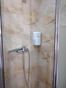 a bathroom with a shower with a glass door at Casa das Laranjeiras in Pinhão