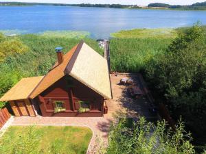 an aerial view of a log cabin with a lake at Ferienhaus Haus am See in Sternberg +10 photos