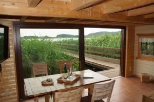 a dining room with a table and a large window at Ferienhaus Haus am See in Sternberg