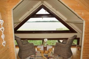 a room with a table and chairs and a large window at Ferienhaus Haus am See in Sternberg