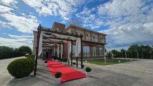 a building with a red carpet in front of it at B&B Andero Deva in Deva